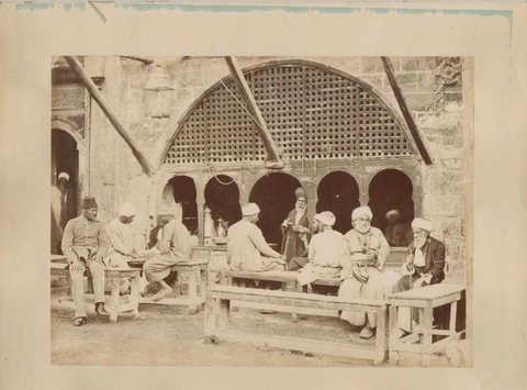 Traditional cafe in Cairo in the 19th century, showing nargiles, coffees being served, varying ages 