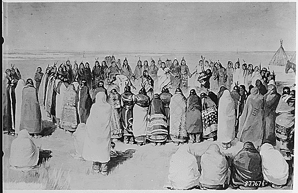 A group of people encircle others who appear to be engaged in a ceremonial dance.