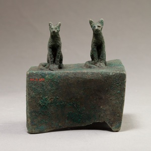 Two cats surmounting a box for an animal mummy