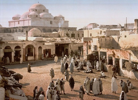This color lithograph depicts the Bazaar of Bab Souika, next to Sidi Mahrez Mosque in Tunis, in 1899