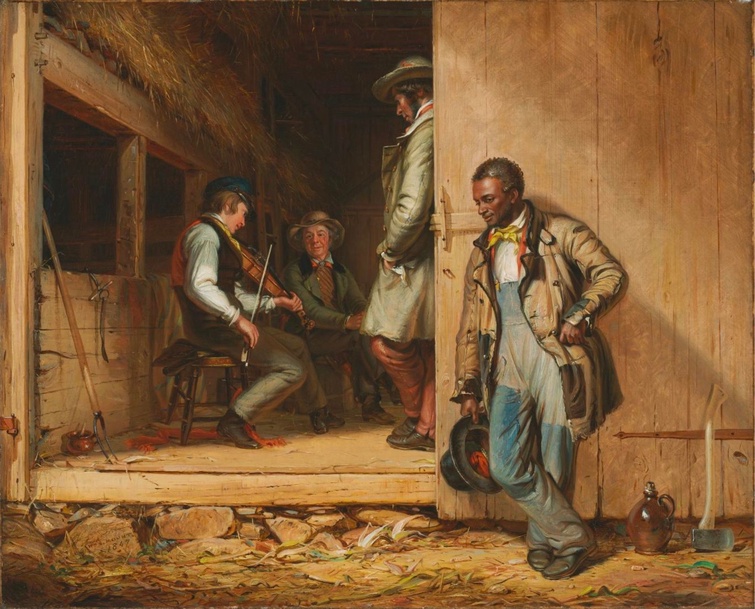 Standing outside a barn, an African American laborer in work overalls listens to a young white man i