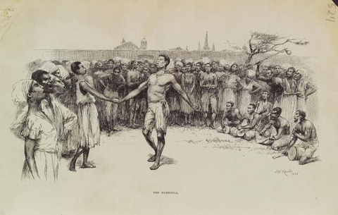 A man stands holding the hand of a woman in the middle of a crowd while men drum and people sing. 