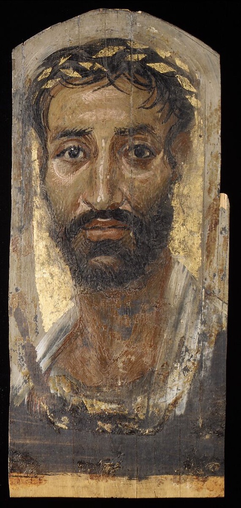 A portrait of a man with dark hair and large round eyes. He is painted with a beard and a white clas